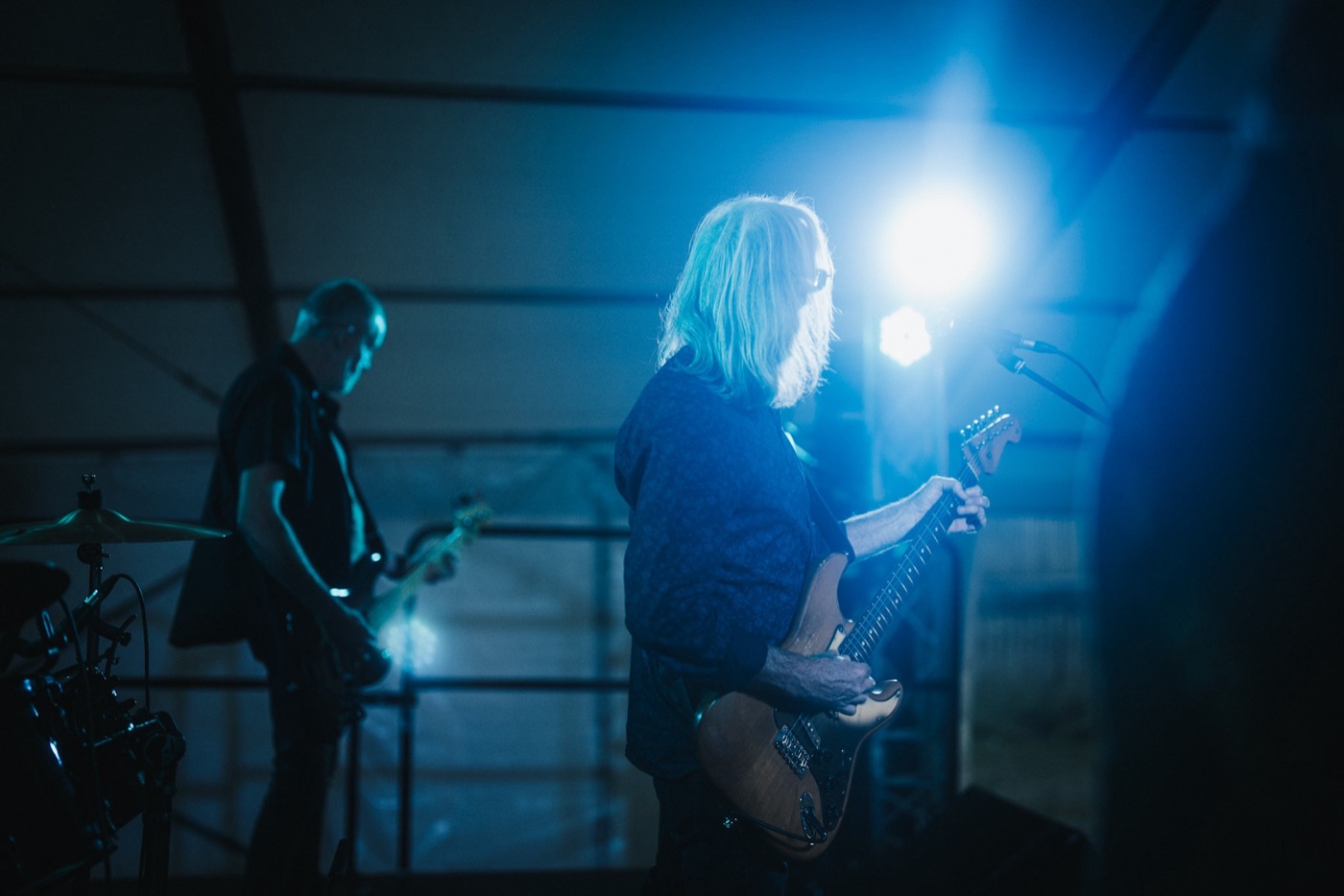 Musician performing under blue stage lights